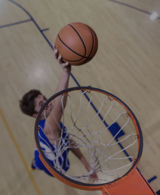A student practicing at a basketball training session
